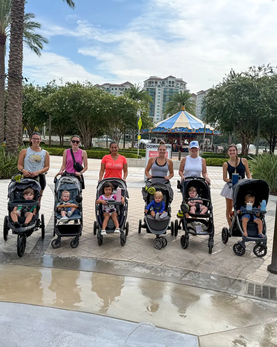 Families lined up with strollers by the carousel