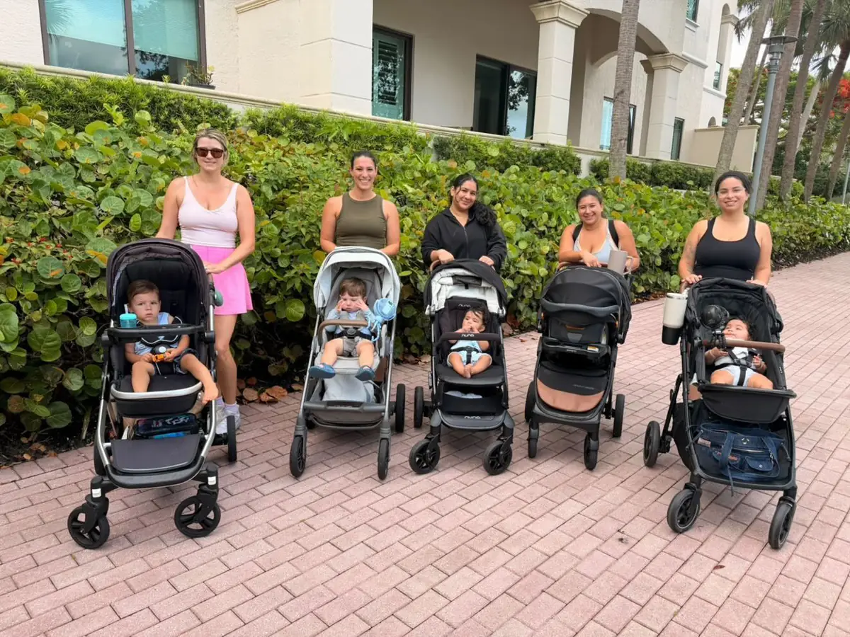 Moms with strollers on a brick walkway