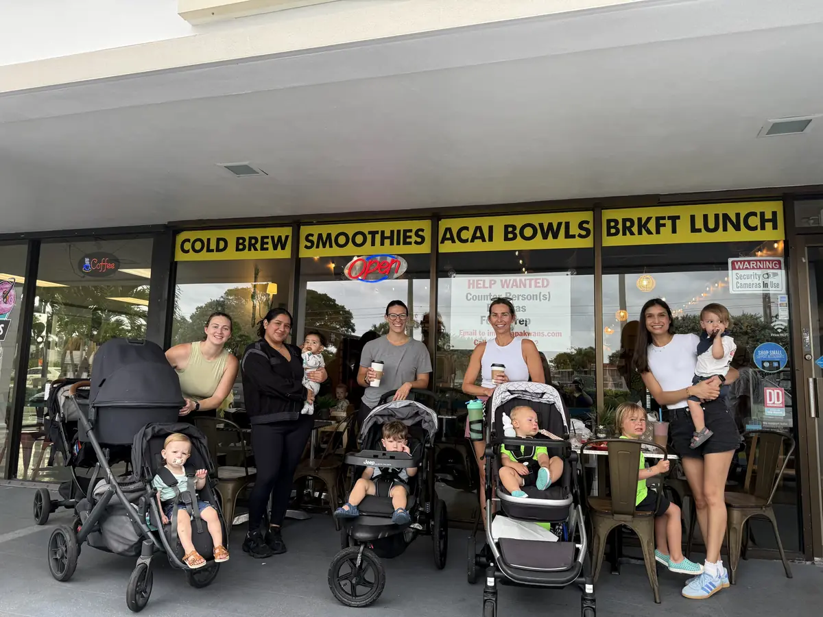 Families with strollers outside a cafe after a walk